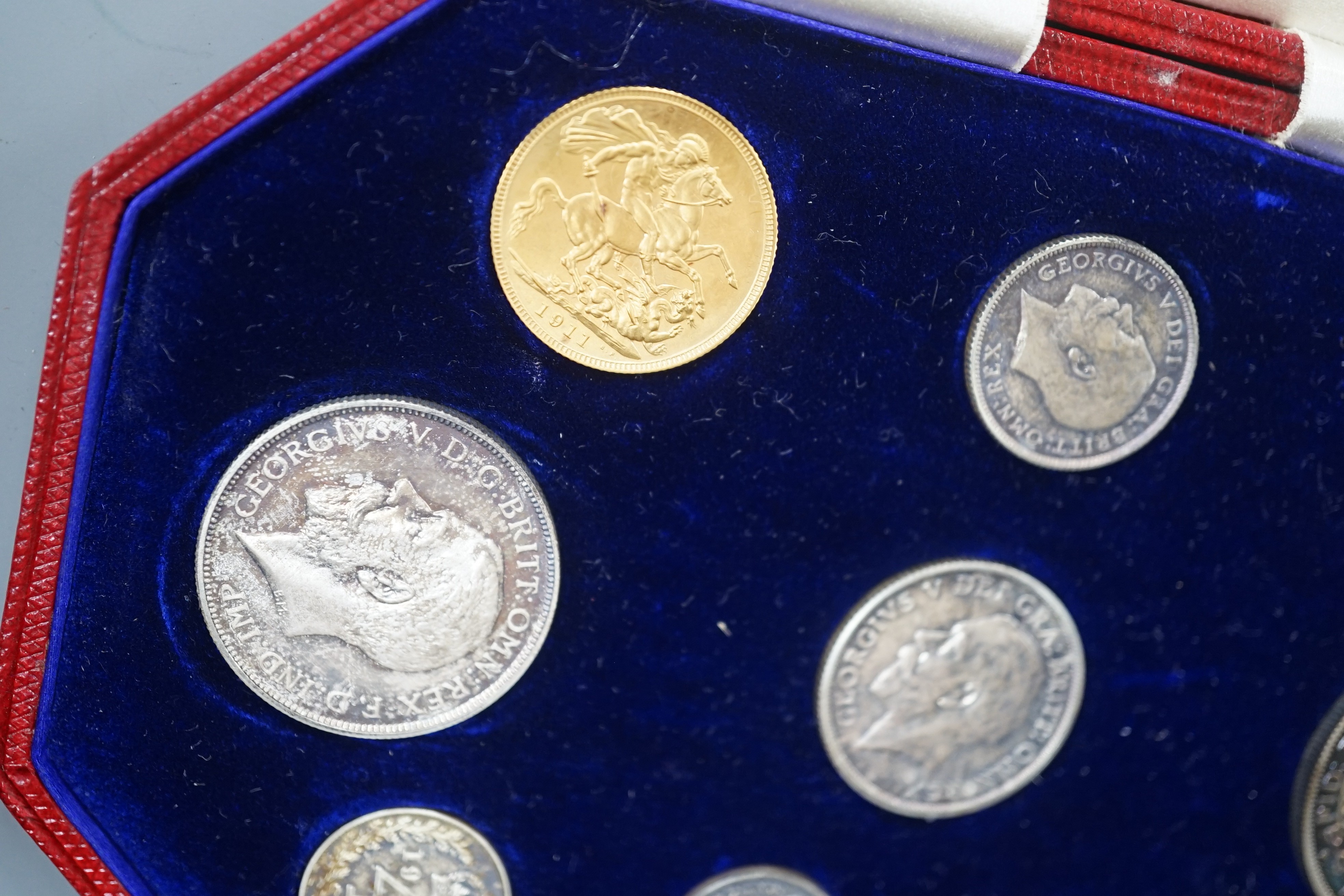 A George V specimen coin set 1911, comprising gold sovereign, and half sovereign, silver half crown, florin, shilling, 6d and Maundy 1d– 4d, UNC with toning to silver coins
